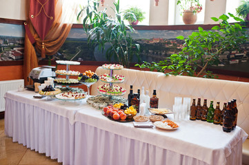 Dessert table of delicious sweets on wedding reception.