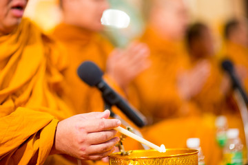 Buddha monk hold candlestick above holy water bowl. religion ceremony. Buddhist holy water. image for copy space.