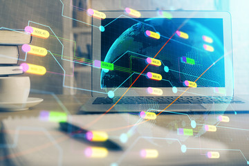 Multi exposure of table with computer and world map hologram. International data network concept.