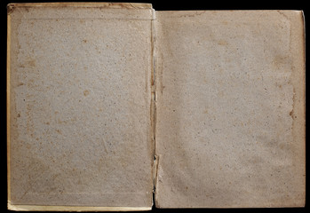 Antique book unfolded on the Endpaper, showing aged textured paper inside, isolated on black background.