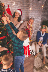 Fototapeta premium Family decorating Christmas tree