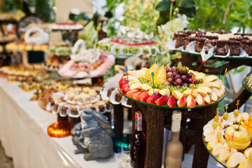 Dessert table of delicious sweets on wedding reception.