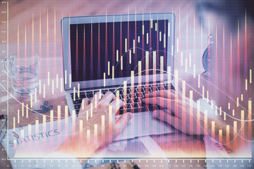 Multi exposure of forex graph with man working on computer on background. Concept of market analysis.