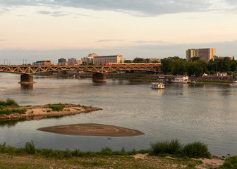 Warsaw, Poland/Europe; 12/07/2019: Railway bridge over the Vistula river at sunset in Warsaw, Poland