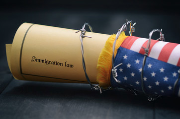 Barbed wire , Immigration Law and flag of United States Of America stock photo