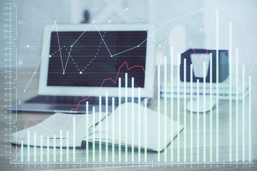 Financial chart drawing and table with computer on background. Multi exposure. Concept of international markets.