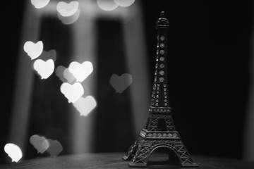 miniature eiffel tower with bokeh behind