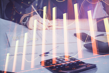 Double exposure of man doing analysis of stock market with forex graph.