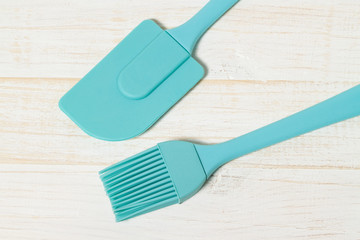 Silicone tools aquamarine with white wood background