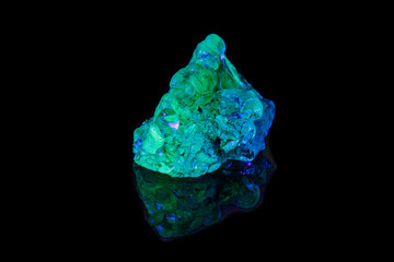 Fototapeta premium macro mineral stone opal under ultraviolet light on a black background