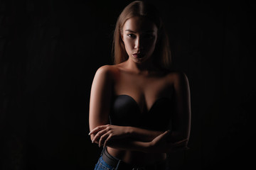 Fototapeta na wymiar portrait of a beautiful girl on a dark background