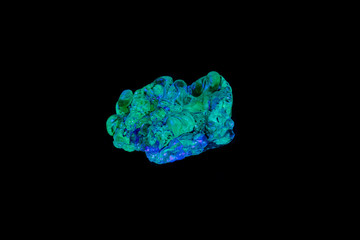 macro mineral stone opal under ultraviolet light on a black background