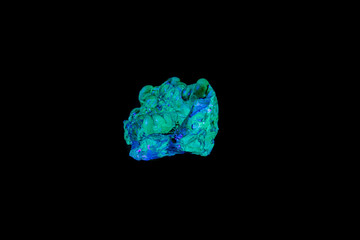 Fototapeta premium macro mineral stone opal under ultraviolet light on a black background