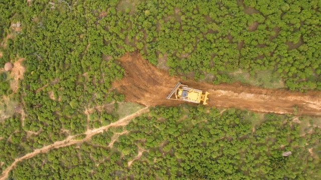 Aerial view of bulldozer deforestation trees in mountains of Marbella, Spain.