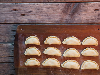 dumplings on a cutting board on a rustic table