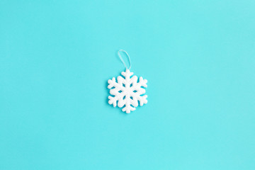 white snowflake on blue background. Christmas composition.