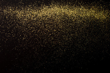 Christmas Gold glitter on black background. Holiday abstract