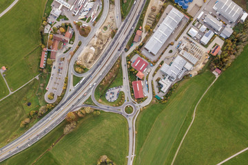 Top down aerial view of freeway interstate road with moving traffic cars in rural area.