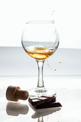 strong alcohol is poured into a glass glass
