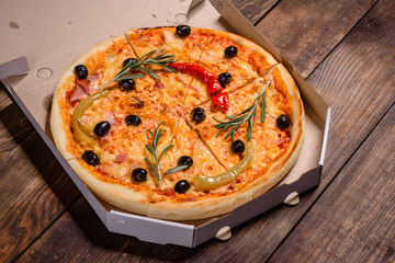 Tasty fresh hot pizza against a dark background. Pizza, food, vegetable, mushrooms