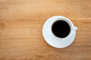 Top view cup of coffee on wooden table.