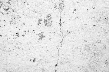 Texture of a concrete wall with cracks and scratches which can be used as a background