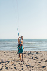 KItesurfer Standing on Sandy Beach