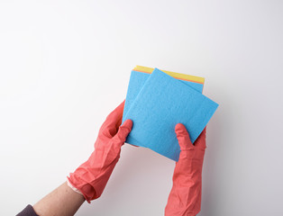 blue square absorbent sponges in their hands wearing red rubber gloves, white background