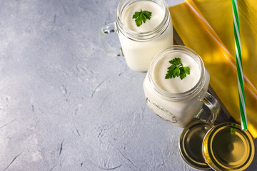 simple homemade kefir in a glass with spices and herbs on a gray background, copy space. Probiotic Ayran