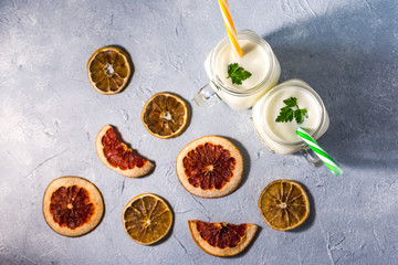 simple homemade kefir in a glass with spices and herbs on a gray background, copy space. Probiotic...