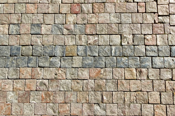 An old stoneblock pavement cobbled with square stone blocks