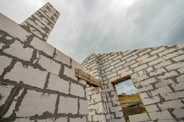 Building site of a house under construction made from white foam concrete blocks.