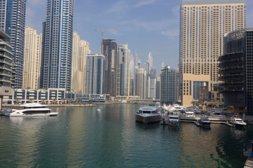 Fototapeta na wymiar view from the pier of Dubai marina with its boats and skyscrapers