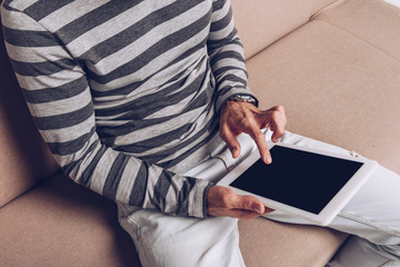 partial view of man using digital device with blank screen