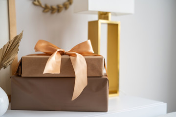Gift box with ribbon and bow on wooden table