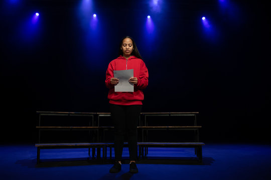 Teenagers rehearsing in a theatre