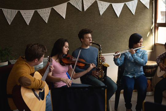 Teenage musicians rehearsing