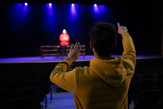 Teenagers rehearsing in a theatre