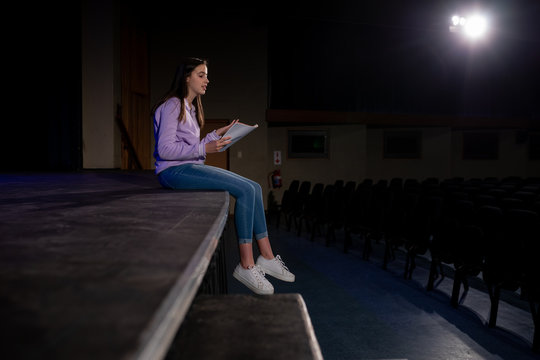 Teenagers rehearsing in a theatre