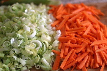 Chopped carrots and leek on a cutting board. Selective focus.