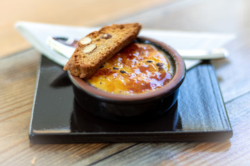Catalan cream (Creme Brulee) with carquinyolis, typical dessert in Nort Spain, Catalonia