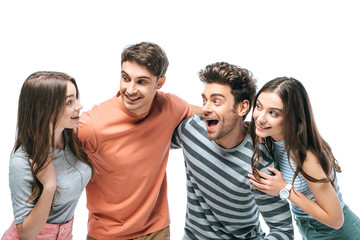 surprised friends screaming and hugging together isolated on white