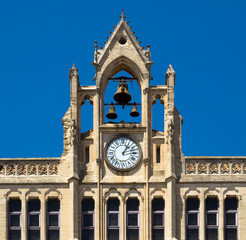 Ancient Clock on Bell Tower of Narbonne city hall, sightseeing on city tour. Medieval architecture and landmarks on the Southern of France, french province of Languedoc-Roussillon.