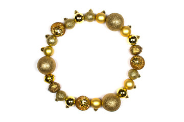 Round frame in form of Christmas wreath of New Year's golden balls. Layout for design flat lay, place for text. Christmas balls of different sizes and textures. Merry Christmas and a happy new year.