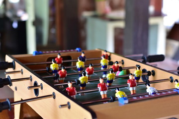 Table football game, there are red and yellow players, soft focus.