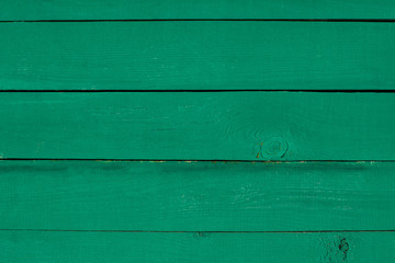 Fototapeta premium Colorful emerald painted wooden background. Vintage timber texture. Aged fence planks.