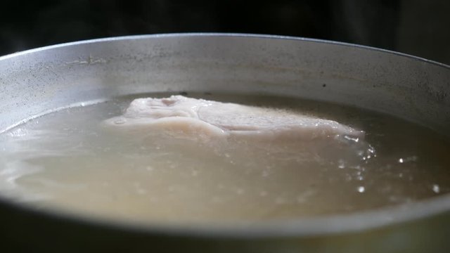 Metallic casserole with boiling ukha, a traditional Ukrainian fish soup with vegetables 