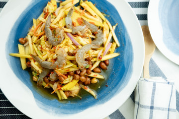 Spicy and sour mangoes salad with raw fresh shrimp