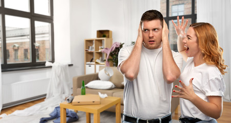 relationship difficulties, conflict and violence concept - unhappy couple having argument over messy home room background