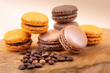 Macaroons and coffee beans on a wooden board
